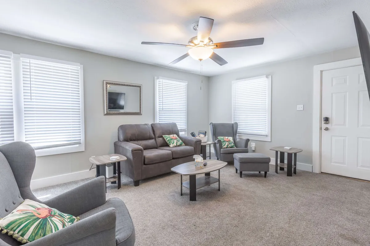 A comfortable living area with sofas, coffee tables, and decorative pillows, arranged to encourage relaxation and socializing. The decor is warm and inviting, perfect for family downtime.